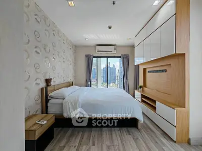 Modern bedroom with city view, featuring stylish decor and ample natural light.
