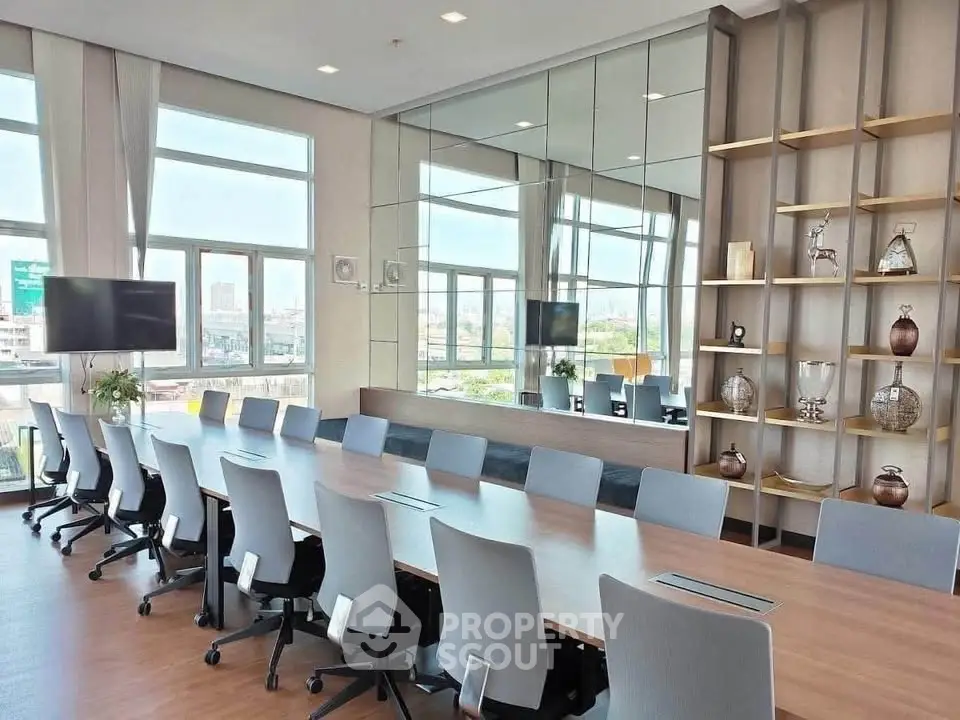 Modern conference room with large windows and city view, featuring sleek design and ample seating.
