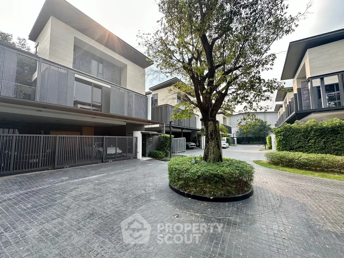 Modern luxury townhouse with sleek design and lush greenery in a serene neighborhood.