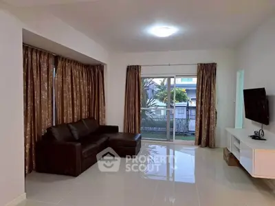 Spacious living room with modern sofa and large window view