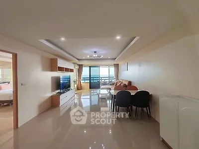 Spacious living room with modern furnishings and balcony view