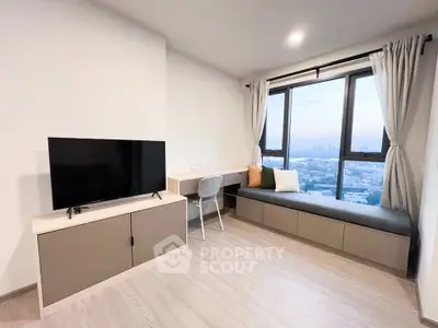 Modern living room with city view, featuring sleek furniture and large windows for natural light.