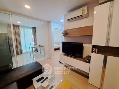 Modern living room with sleek furniture and air conditioning in a stylish apartment.