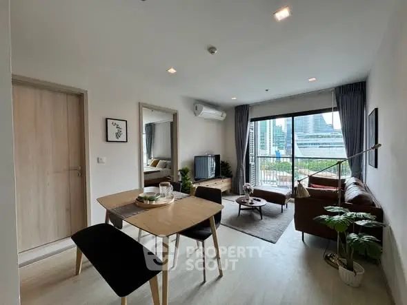 Modern living room with city view, stylish furniture, and natural light.