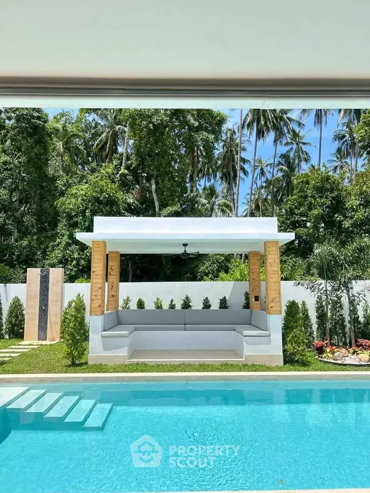 Luxurious outdoor pool area with modern cabana and lush greenery, perfect for relaxation and entertainment.