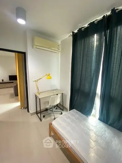 Cozy bedroom with study desk and natural light