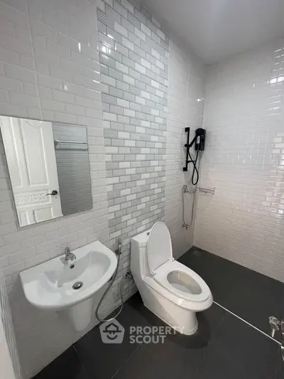 Modern bathroom with sleek white tiles and contemporary fixtures
