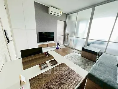 Modern living room with sleek furniture and large windows for natural light.