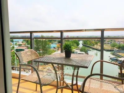 Charming balcony with river view and cozy seating area