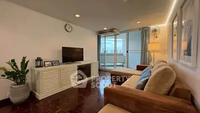 Spacious living room with modern decor and balcony view in a stylish apartment.
