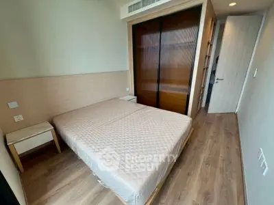 Modern bedroom with wooden flooring and built-in wardrobe