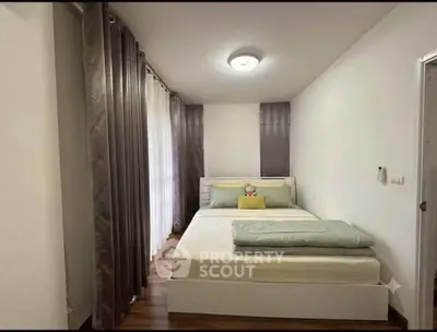 Cozy bedroom with modern decor and ample natural light