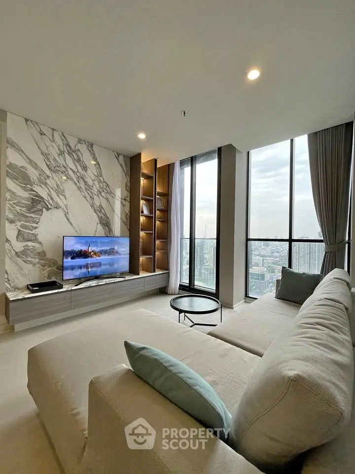 Luxurious living room with stunning city view and modern marble accent wall.