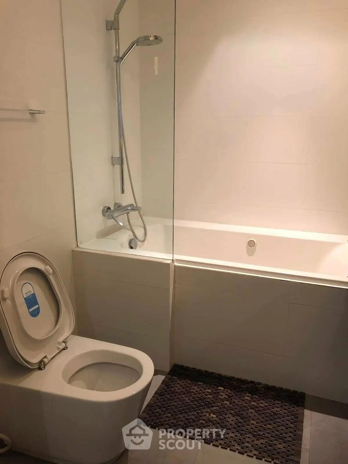 Modern bathroom with bathtub and shower, featuring sleek design and neutral tones.