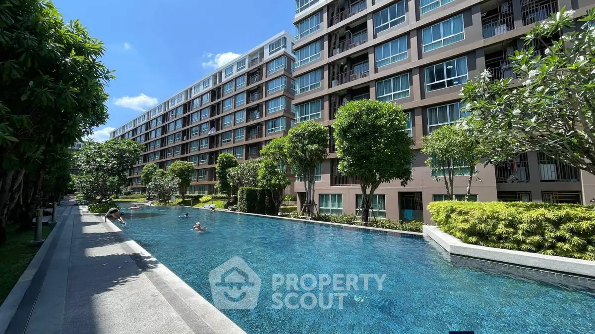 Luxurious condominium with a stunning outdoor pool and lush greenery, perfect for relaxation and leisure.