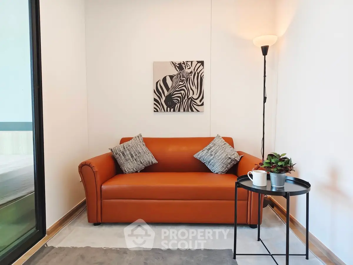 Cozy living room with stylish orange sofa and zebra artwork, perfect for modern urban living.