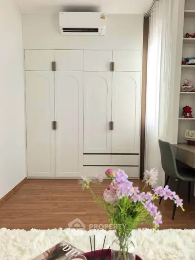 Stylish bedroom with modern wardrobe and air conditioning, perfect for comfort and organization.