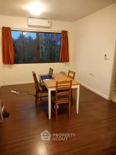 Cozy study area with wooden flooring and natural light, perfect for productivity.