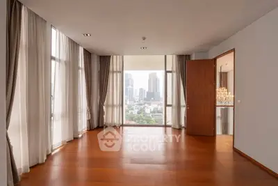 Spacious corner unit with floor-to-ceiling windows offering a stunning city view, perfect for modern living.