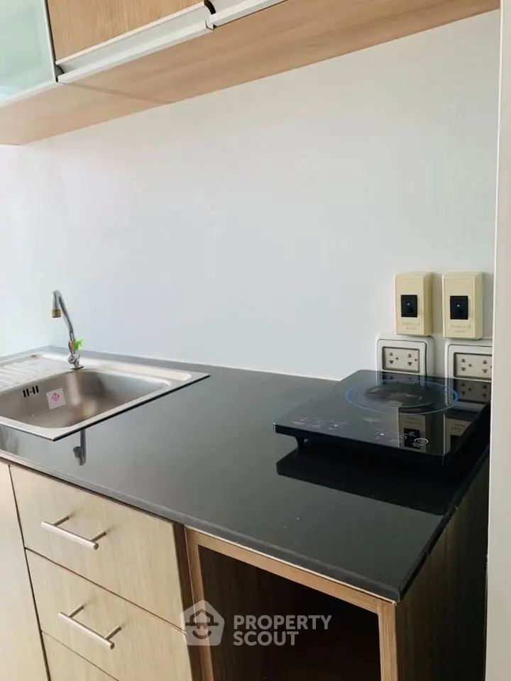 Modern kitchen with sleek black countertop and induction cooktop