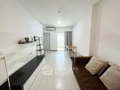 Modern living room with sleek furniture and natural light, perfect for urban living.