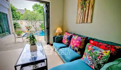 Charming living room with vibrant decor and poolside view, perfect for relaxation and entertaining.