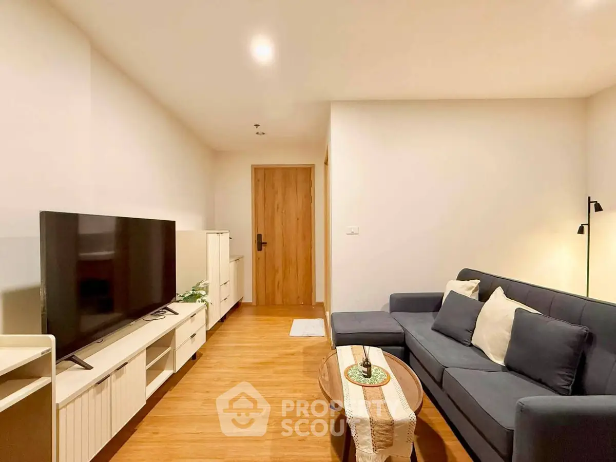 Modern living room with sleek furniture and wooden flooring