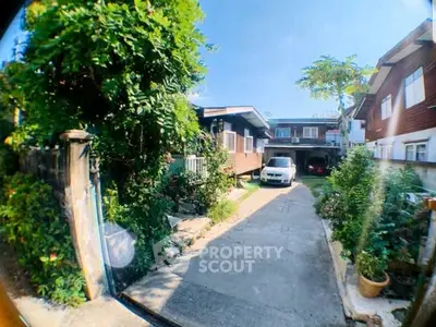 Charming residential property with lush greenery and spacious driveway