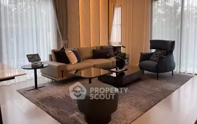 Luxurious modern living room with elegant furniture and large windows