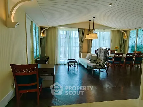Spacious living room with elegant decor and large windows for natural light.