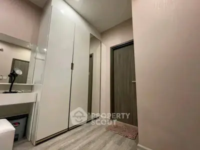 Modern bedroom with sleek wardrobe and vanity area