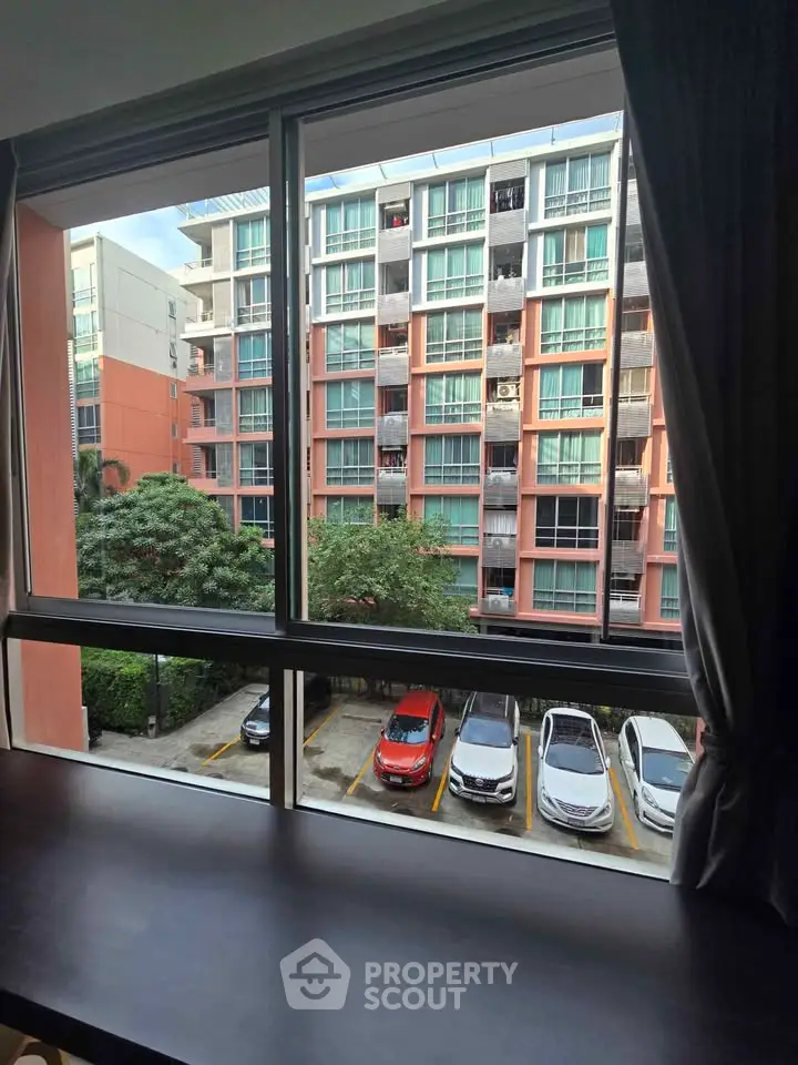 Modern apartment view with parking and urban landscape from window