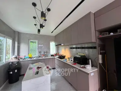 Modern kitchen with sleek cabinetry and island in a bright, spacious layout