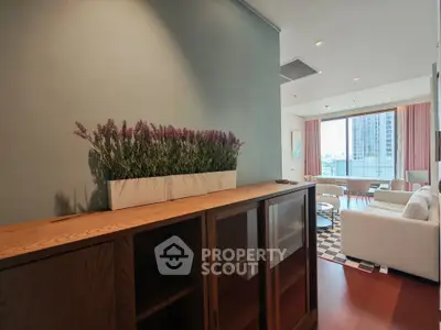 Stylish living room with modern decor and city view, featuring elegant furniture and natural light.