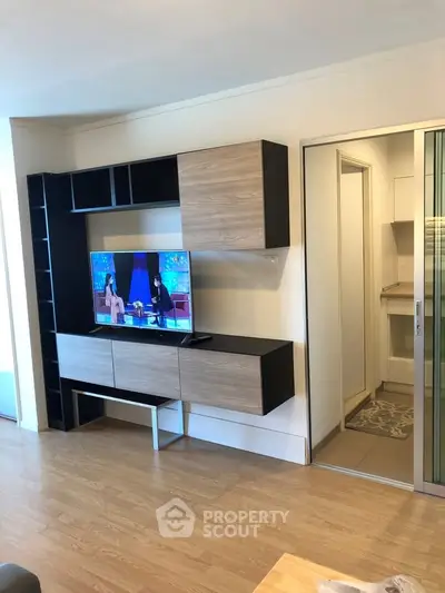 Modern living room with stylish TV unit and wooden flooring