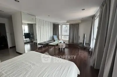 Spacious modern bedroom with large windows and stylish decor