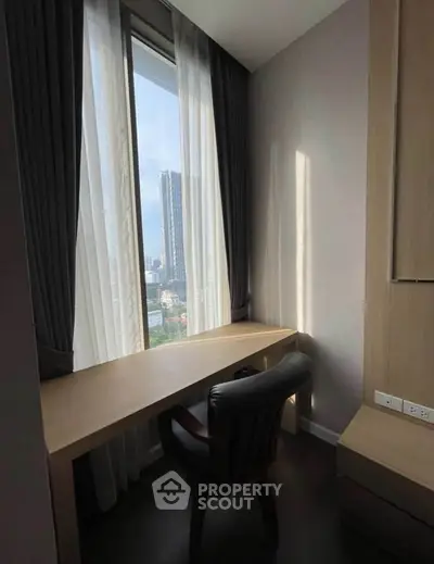 Modern study room with large window offering stunning city view, perfect for work-from-home setup.