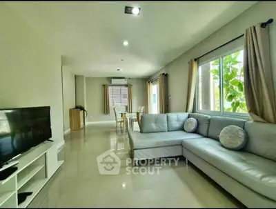 Spacious living room with modern decor and large windows for natural light.