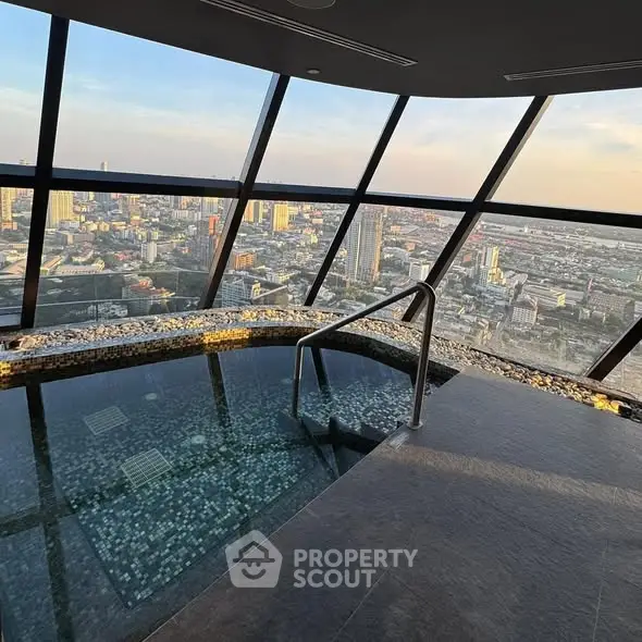 Stunning rooftop pool with panoramic city views in luxury high-rise building.