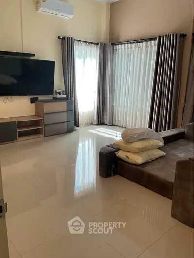 Spacious living room with modern decor and large windows for natural light.