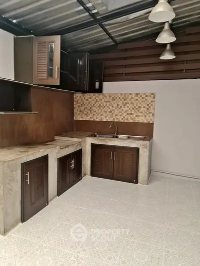 Modern kitchen with stylish cabinets and tiled backsplash in a contemporary home.