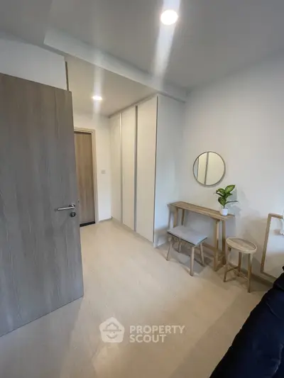 Modern minimalist bedroom with sleek furniture and ample storage space