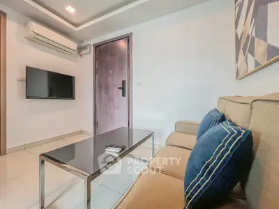 Modern living room with sleek furniture and wall-mounted TV