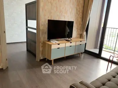 Modern living room with stylish TV stand and large balcony window