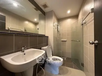 Modern bathroom with sleek fixtures and glass shower enclosure