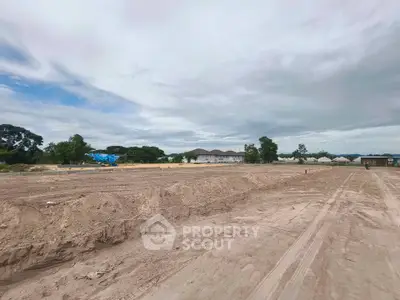 Expansive land plot with potential for development under a vast sky, ideal for real estate investment.