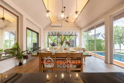 Luxurious open-plan living room with pool view and elegant dining setup.