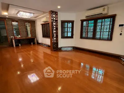 Spacious living room with wooden flooring and elegant lighting