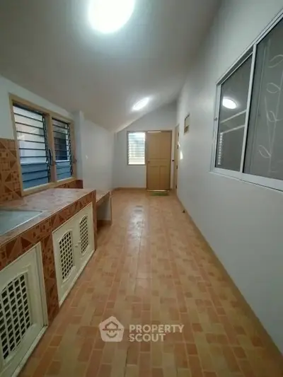 Spacious tiled hallway with natural light and modern design