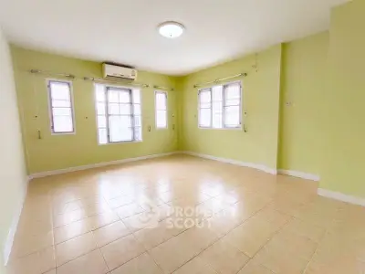 Spacious empty room with tiled floor and large windows, perfect for customization.
